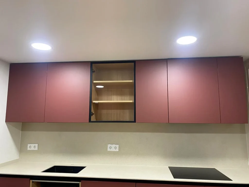 Cocina reformada con muebles altos en tono burdeos y vitrina con perfil negro, en el paseo de Arroyomolinos (Móstoles)